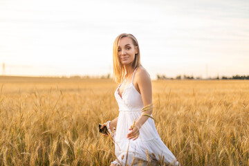 woman in wheat field at sunset