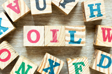 Alphabet letter block in word oil with another on wood background