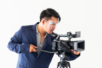 Young asian man wearing face shield and holding video camera. Reporting about covid19 spread on...