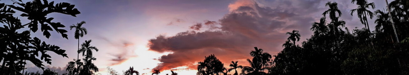 Beautiful photo of nature panorama, with sunset on the sky and clouds among forest natural area in countryside, Thailand.