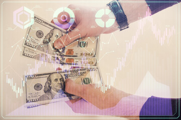 Fototapeta na wymiar Multi exposure of financial graph drawing hologram and USA dollars bills and man hands. Analysis concept.
