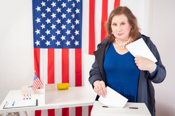 US elections. Female voter from USA. America presidential election. American woman throws a...