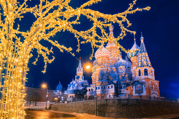 Moscow. Russia. St. Basil's Cathedral. Kremlin. Red Square on a winter night. The tree is decorated with illumination. St. Basil's Cathedral glows at Christmas. New Year. Sights of Russia.