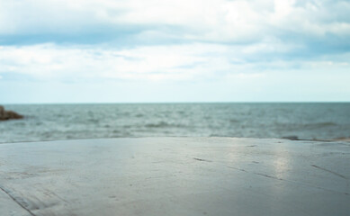 Fototapeta na wymiar Empty stone floor On a blurred sea background.