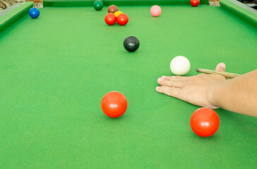 Hand people playing snooker.