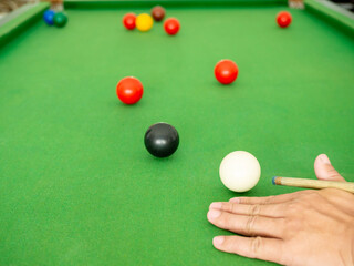Hand people playing snooker.
