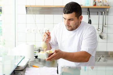 handsome chef  serves food with spoon no hat clipart 
