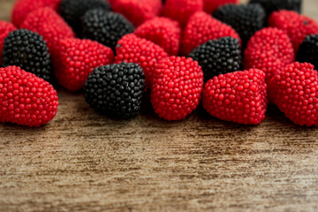Sweet blackberrie red and black rubbers on a wooden surface   