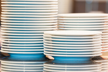 Stacks of Three row big plates for a buffet.