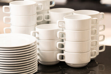 A neatly arranged little soup bowls and plates in a buffet Restaurant or Hotel. Selective focus