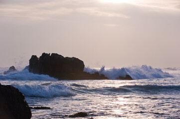 Fototapeta na wymiar Sea coast rocks and wave with the beaytiful sunrise sunshine.