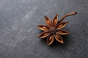 Fragrant star anise stars on a gray concrete countertop