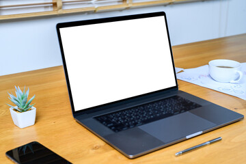 Blank screen laptop computer on wood table with clipping path. business concept. Mockup with space.