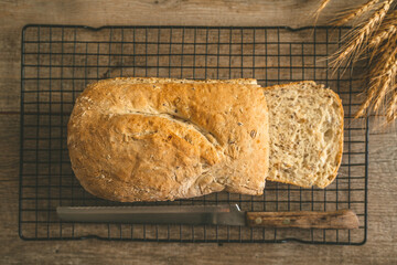 Freshly baked bread on wire rack on a wooden background
