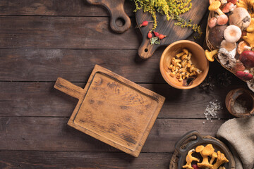 Autumn harvest of mushrooms on vintage rustic wooden background. Rustic kitchen table. Flat lay top, top view . Layout with free text space. Forest harvest concept.
