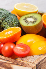 Heap of ripe fruits with vegetables in rustic box. Nutritious food containing healthy minerals and vitamins