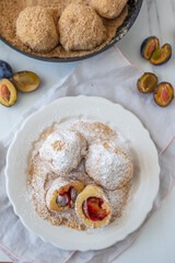 Typical Austrian plum dumplings made of leavened dough and fresh plums