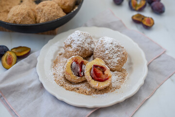 Typical Austrian plum dumplings made of leavened dough and fresh plums