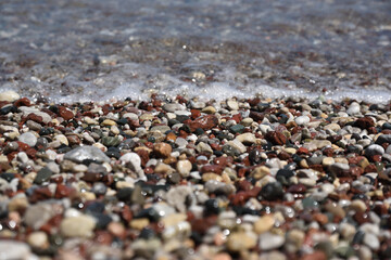 Pebbles in the sea surf on the Aegean coast