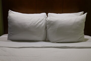 white pillows on a bed 