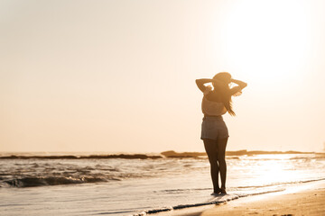 Smile Freedom and happiness chinese woman on beach. She is enjoying serene ocean nature during...