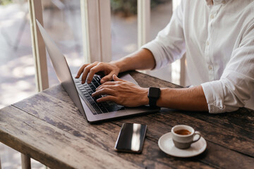 young man working on his computer at the cafe. business, freelance