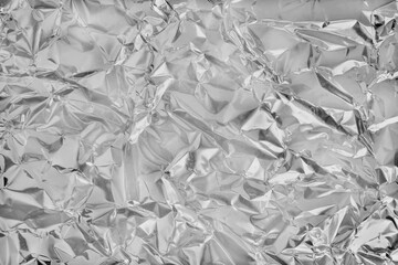 Shiny silver foil texture background, pattern of wrapping paper with crumpled and wavy.