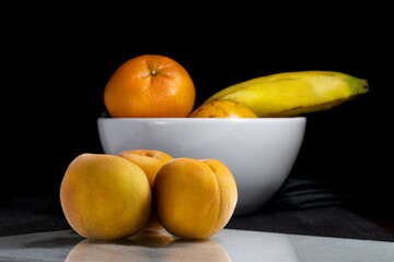 peaches on black background, dark food