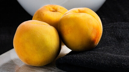 peaches on black background, dark food