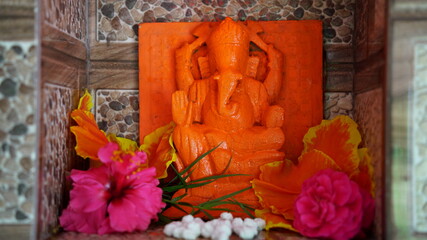 Hindu god lord Ganesha idol, in a marble temple. Beautiful red colored idol, the god of wisdom. Ganesha Chaturathi special.