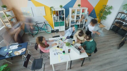 High angle view time-lapse of young people colleagues working in open space office moving around talking. Business and modern lifestyle concept. - Powered by Adobe