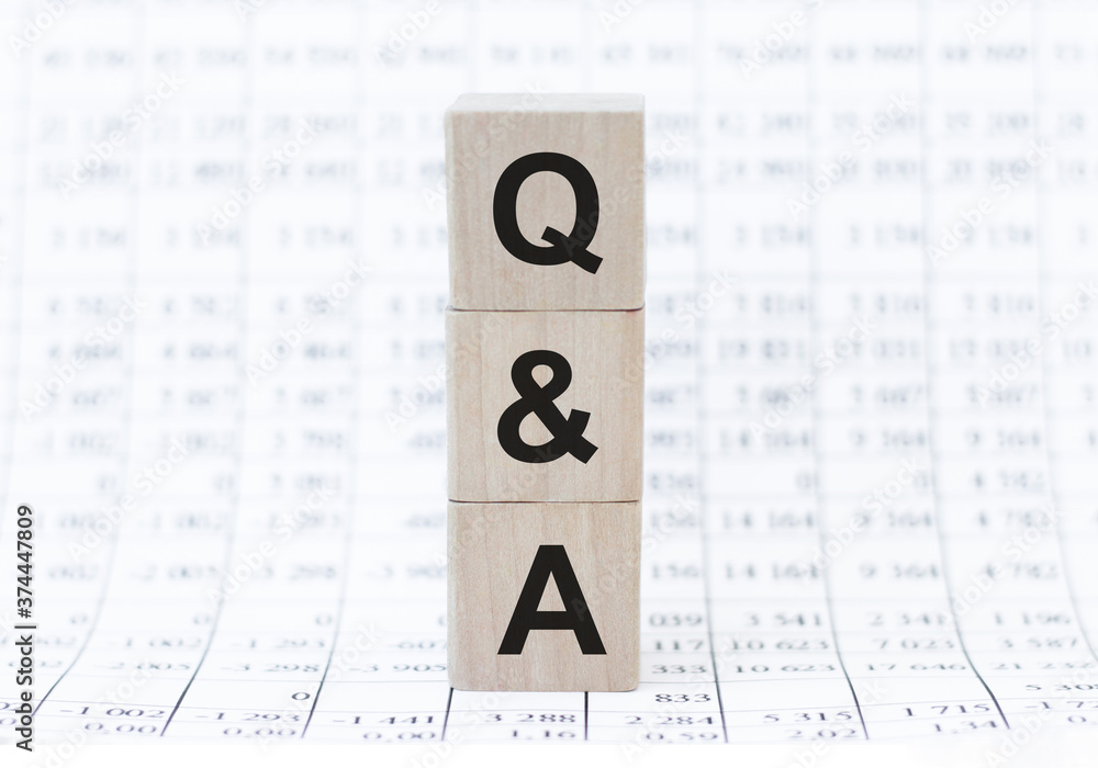 Poster q and a text on the phone screen lying on the laptop keyboard