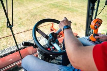 Farmer controls the combine harvester © scharfsinn86