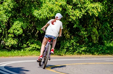 Cyclist ride on the bike path in the city Park
