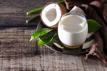Diet and health nutrition concept. Vegan alternative nut milk from coconut on a kitchen table. Copy space.
