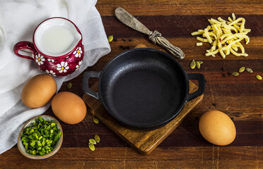 cast iron skillet with eggs on wooden board