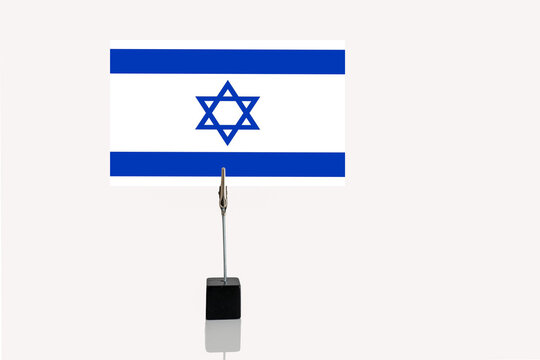 Democratic Republic of Israel  miniature flag in cube base in photograph holder on a white background