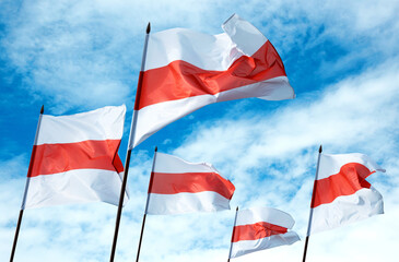 Historical flags of Belarus Republic above blue sky
