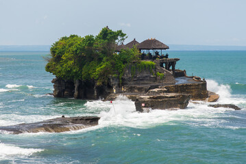 Tanah Lot water temple in Bali. Indonesia nature landscape. Tanah Lot temple in daylight, Bali island. Popular temple of Bali, Indonesia landmark. Famous Bali water temple.