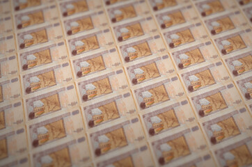 100 Guatemalan quetzales bills printed in illegal money production conveyor. Collage of many fake...