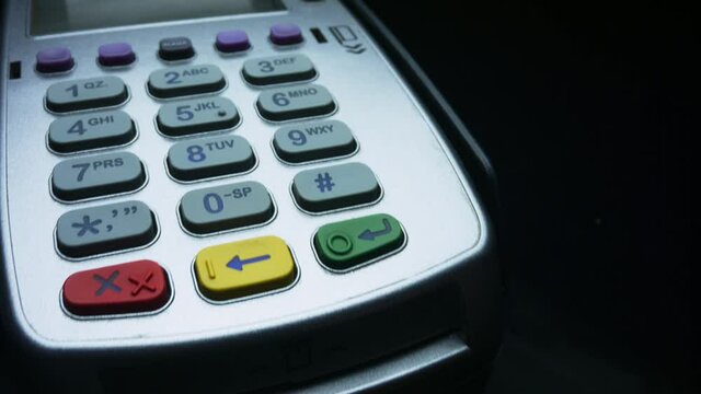 Woman making payment with credit card through terminal.Woman using bank terminal