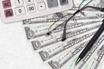 1 US dollar bills fan and calculator with glasses and pen. Business loan or tax payment season...