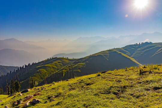sunrise over the lush green mountains - clear sky and grass with dew - siri paye meadows