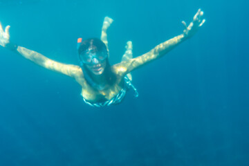 Tourist girl diving on the seabed of Charco Verde on the island of La Palma in summer. Canary...