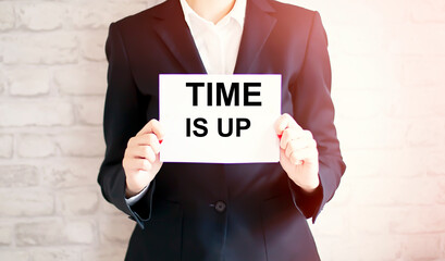 woman showing white card with TIME IS UP word . Business