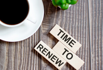 time to renew text on a wooden cubes on a wooden background