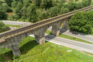 Fototapeta premium Aerial view of railway viaduct in Vorokhta village, Carpathians mountains, Ukraine