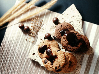 Chocolate chip cookies on rocks and elements Has a black background