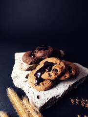 Chocolate chip cookies on rocks and elements Has a black background