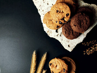 Chocolate chip cookies on rocks and elements Has a black background